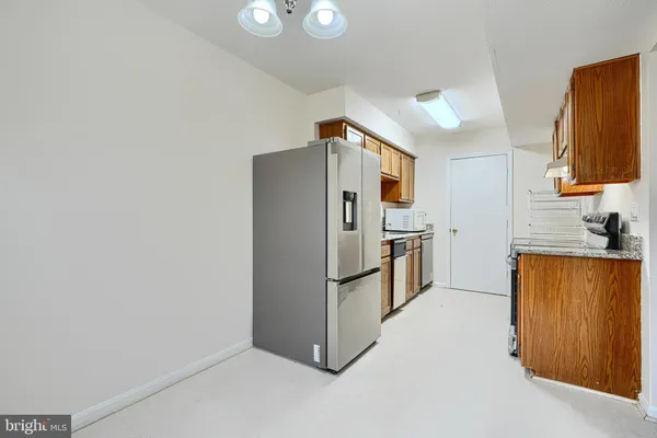 a kitchen with stainless steel appliances a refrigerator and a stove