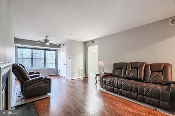 a living room with furniture window and wooden floor