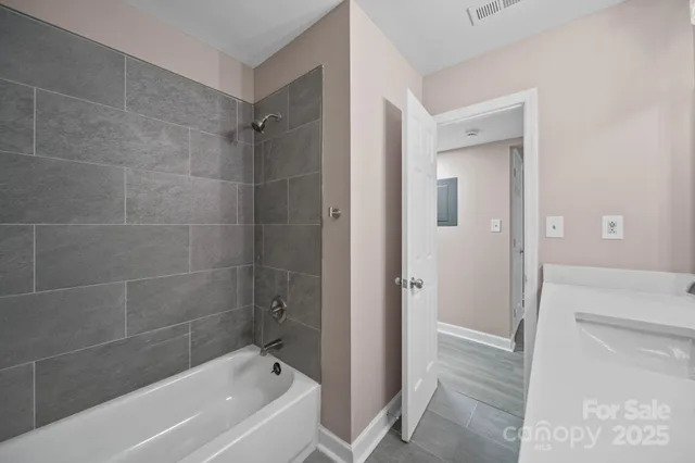 a bathroom with a bathtub shower and toilet