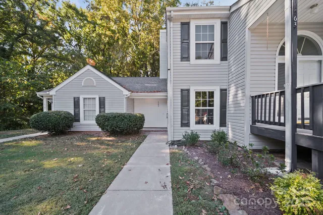 a view of a house with backyard and garden