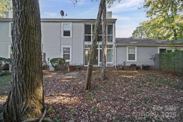 a view of a house with backyard and a tree