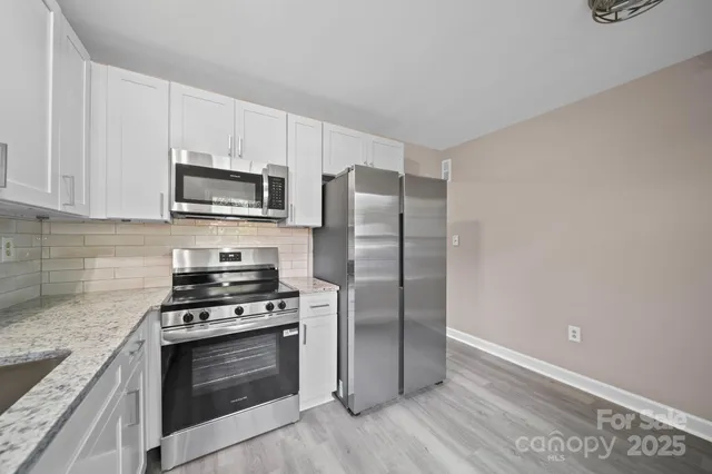 a kitchen with a refrigerator stove and microwave