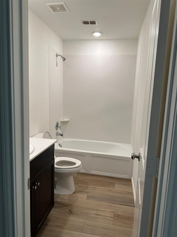 5906 Nyquist Way Forney, TX 75126 - Photo 6 of 27 Bathroom with vanity, wood finished floors, and shower / tub combination