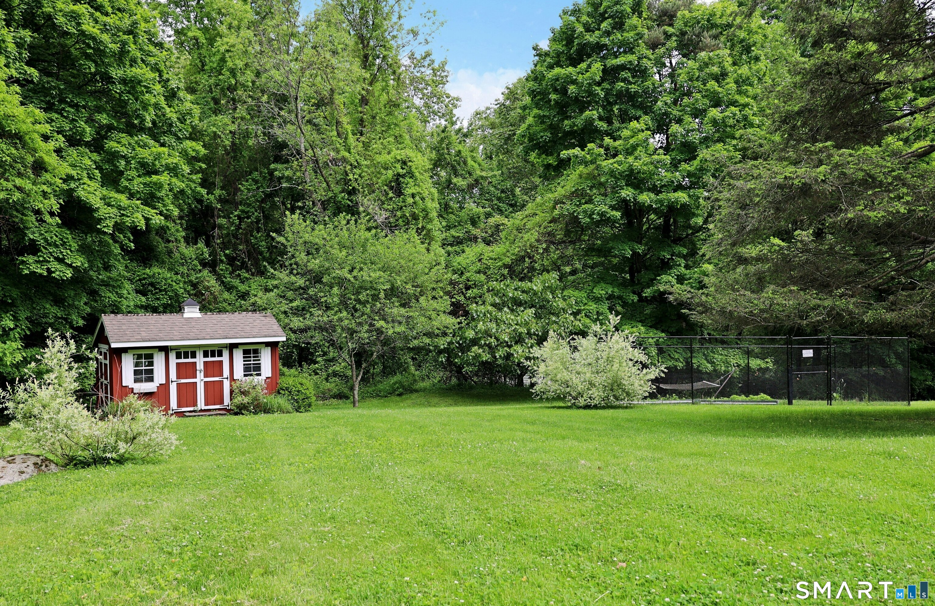 68 Bloomer Road Ridgefield, CT 06877 - Photo 7 of 40 a view of house with a big yard and large trees