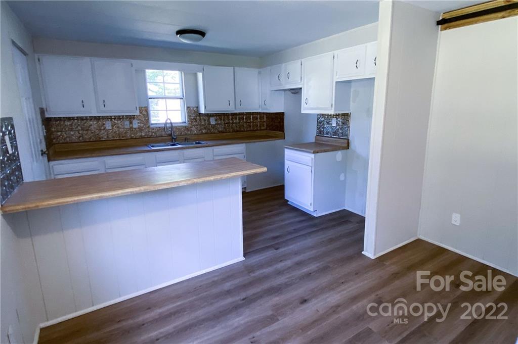 116 Circle Drive Fallston, NC 28090 - Photo 11 of 23 a kitchen with granite countertop wooden floors a stove and a microwave