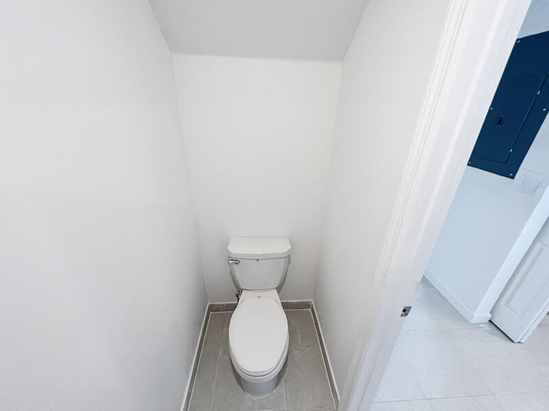 13302 Southwest 286th Street, Unit 13302 Homestead, FL 33033 - Photo 13 of 24 a white toilet sitting next to a white wall