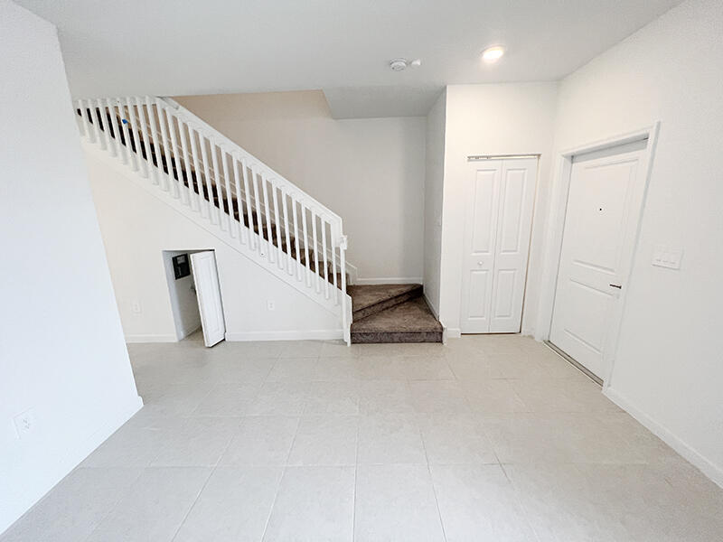 13302 Southwest 286th Street, Unit 13302 Homestead, FL 33033 - Photo 6 of 24 an entryway in a hall with a window