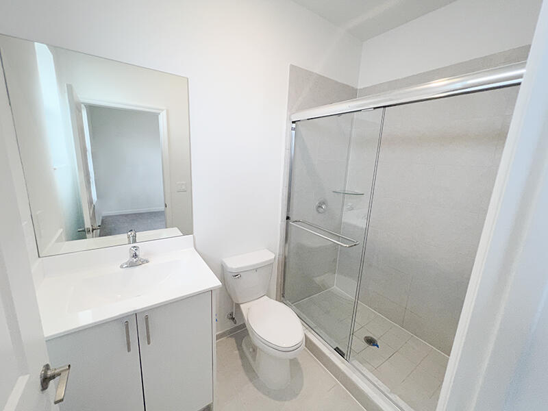 13302 Southwest 286th Street, Unit 13302 Homestead, FL 33033 - Photo 9 of 24 a bathroom with a sink toilet and shower