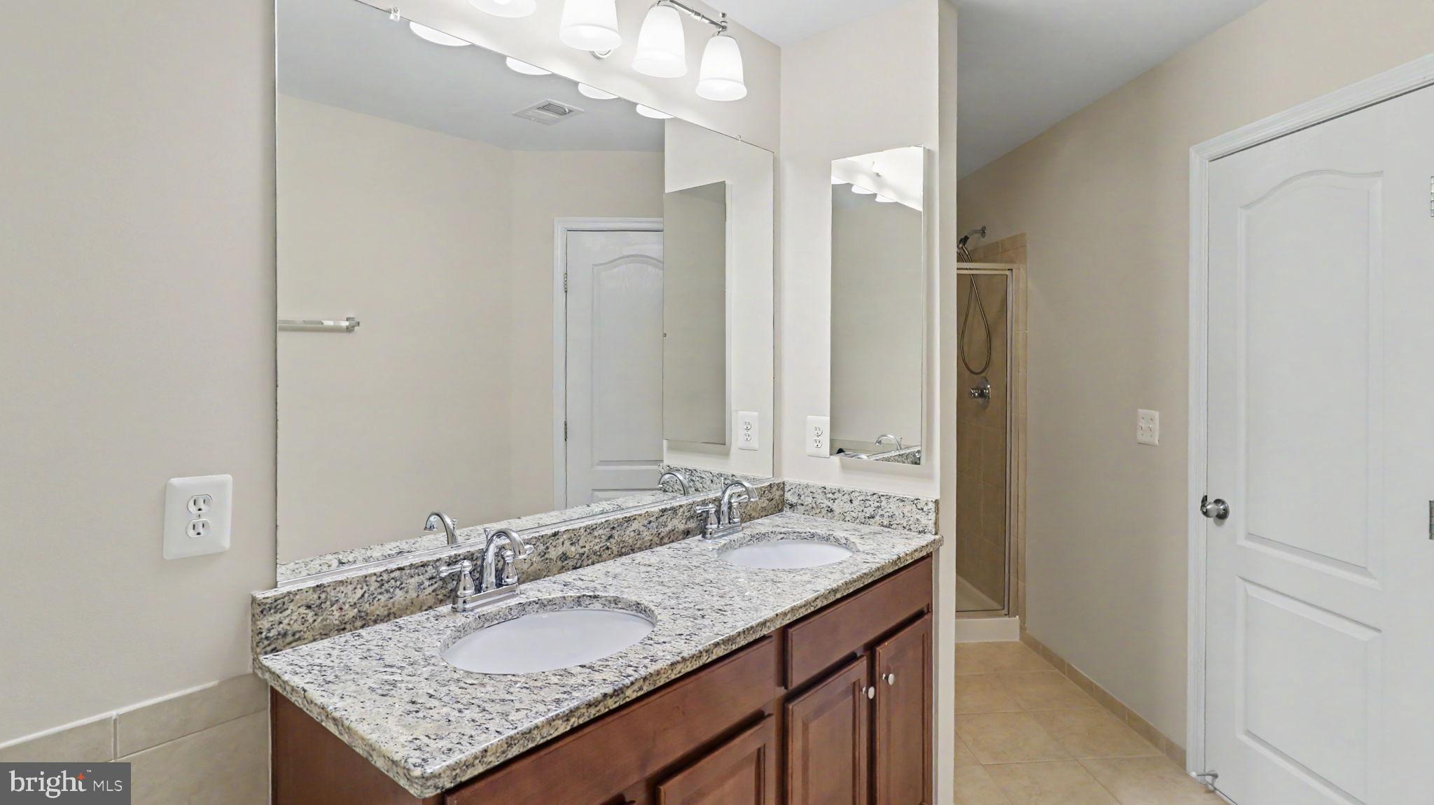 42371 Trellis Square Brambleton, VA 20148 - Photo 42 of 70 Elegant dual-sink bathroom retreat.