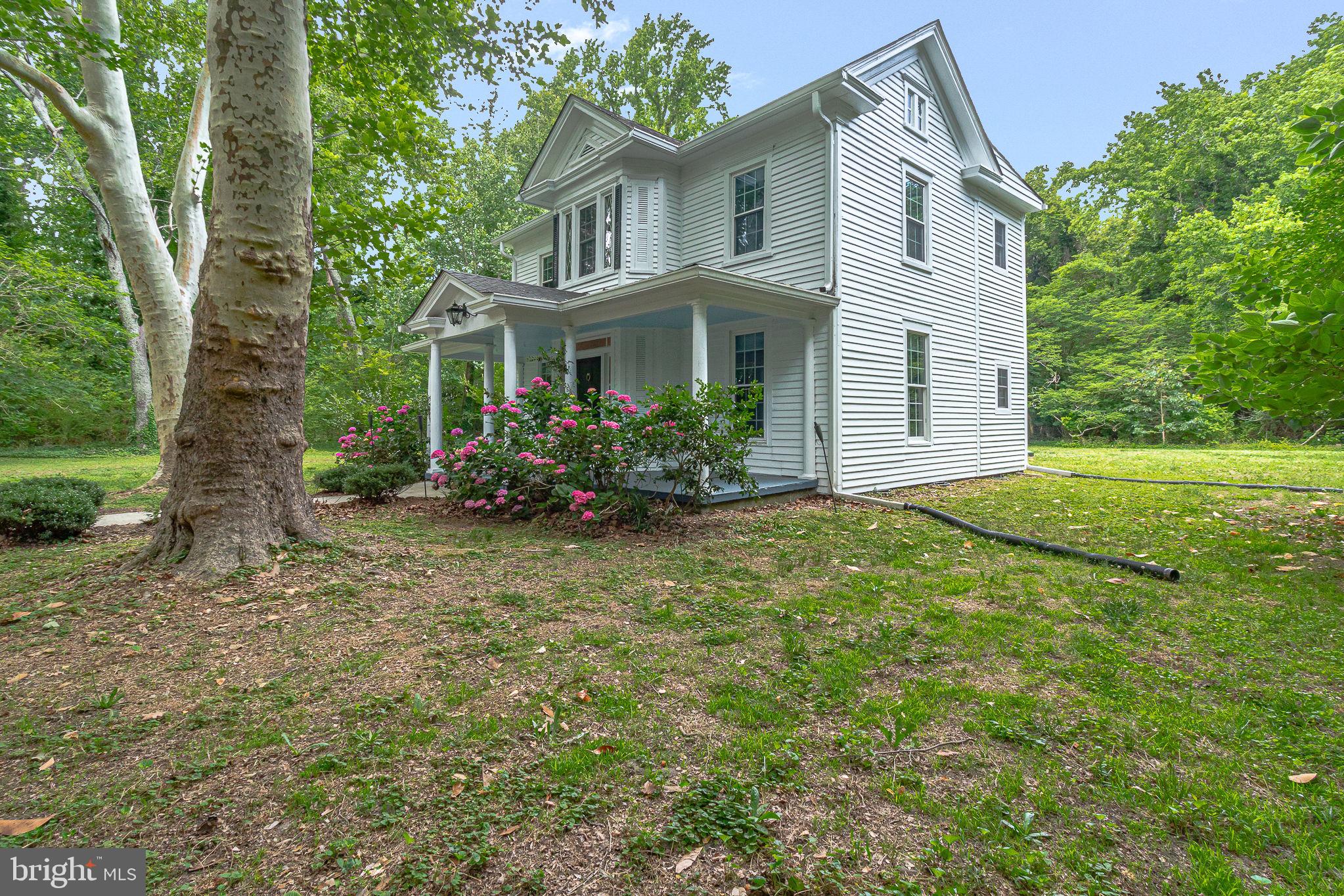 3952 Irvington Road Irvington, VA 22480 - Photo 64 of 77 a view of a white house with a yard and potted plants