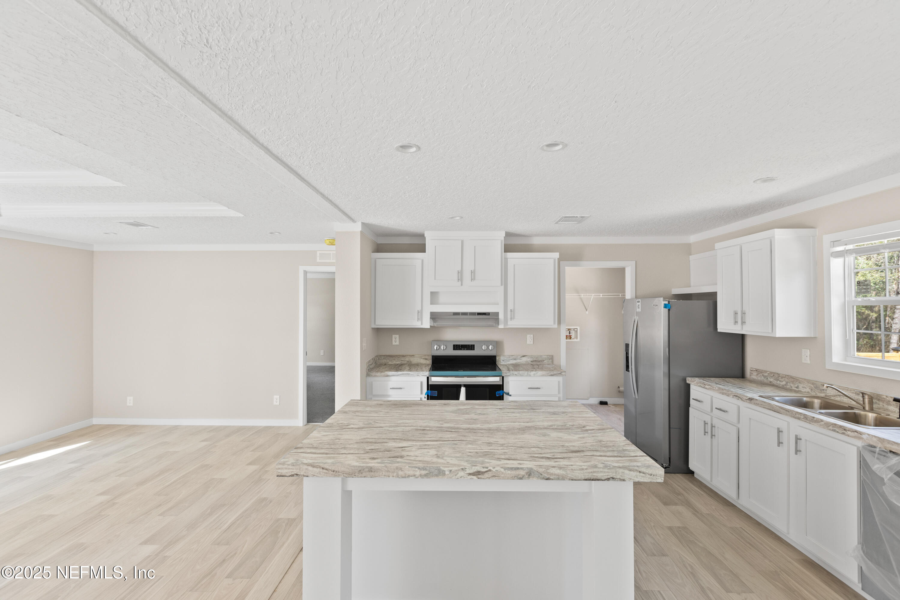 6012 Indian Trail Keystone Heights, FL 32656 - Photo 20 of 61 a kitchen with stainless steel appliances granite countertop a stove refrigerator sink and cabinets