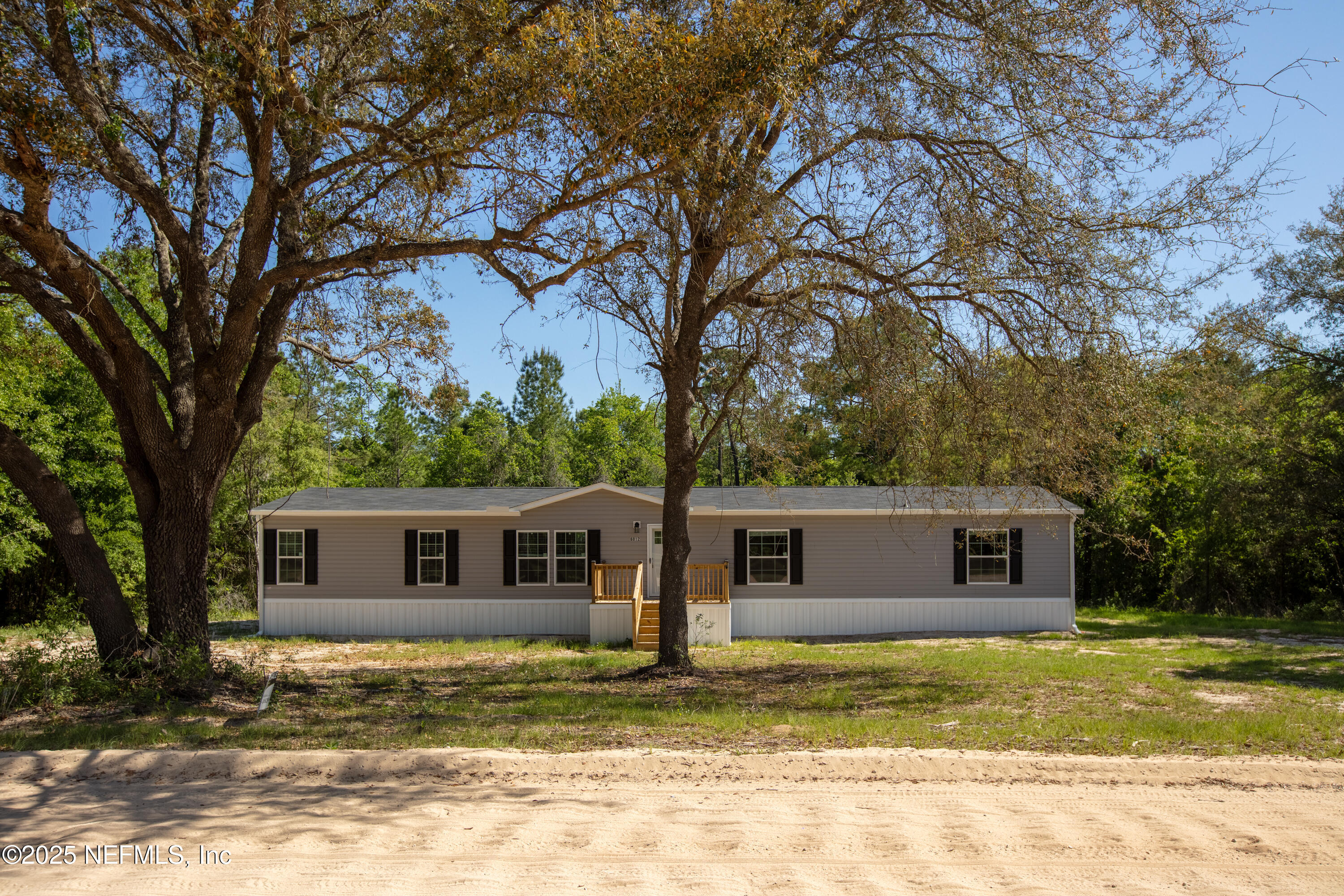 6012 Indian Trail Keystone Heights, FL 32656 - Photo 2 of 61 a front view of a house with a garden