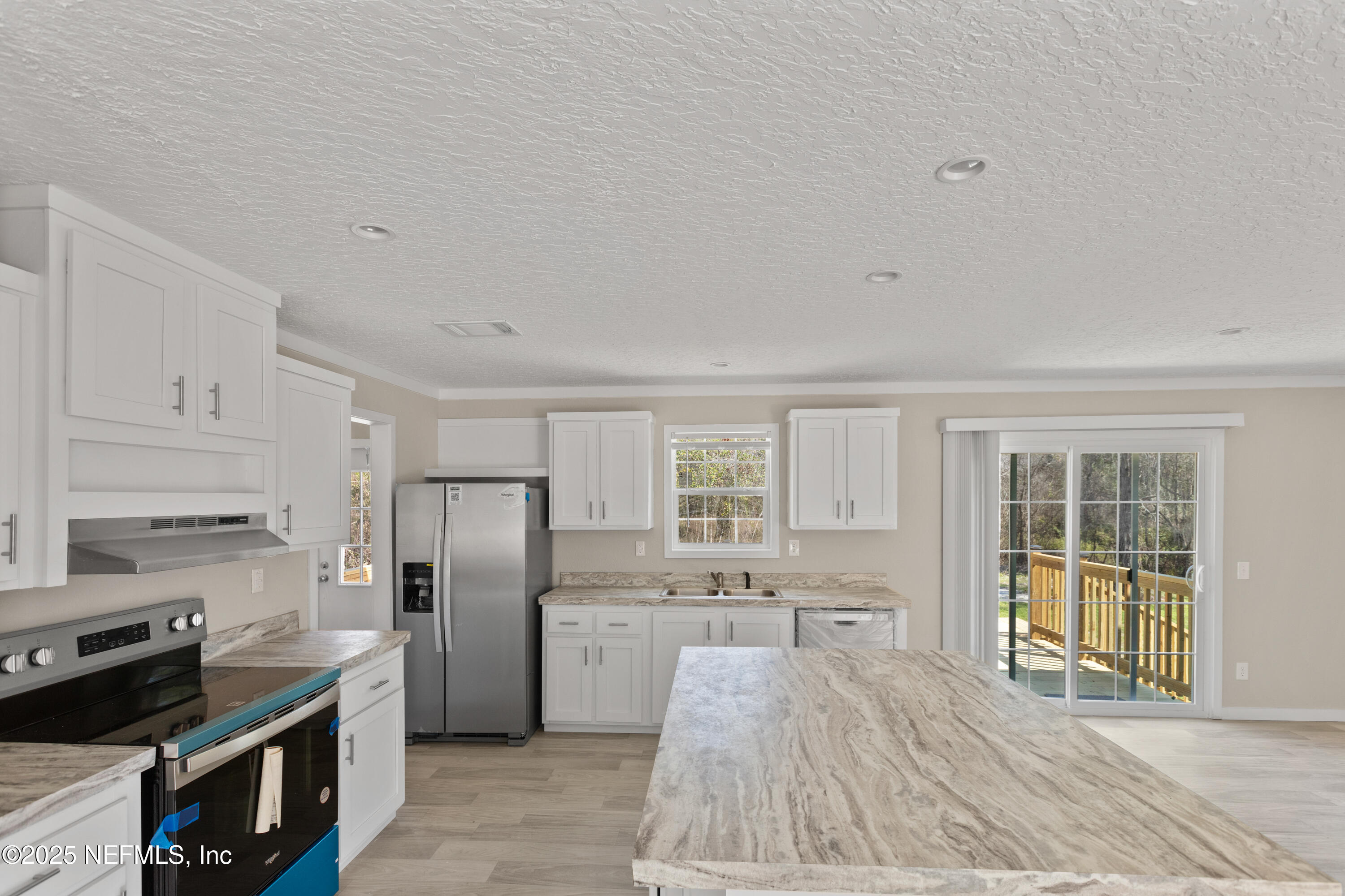 6012 Indian Trail Keystone Heights, FL 32656 - Photo 21 of 61 a kitchen with stainless steel appliances a stove refrigerator sink and cabinets