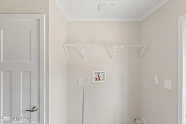 a kitchen with granite countertop a sink a stove and cabinets