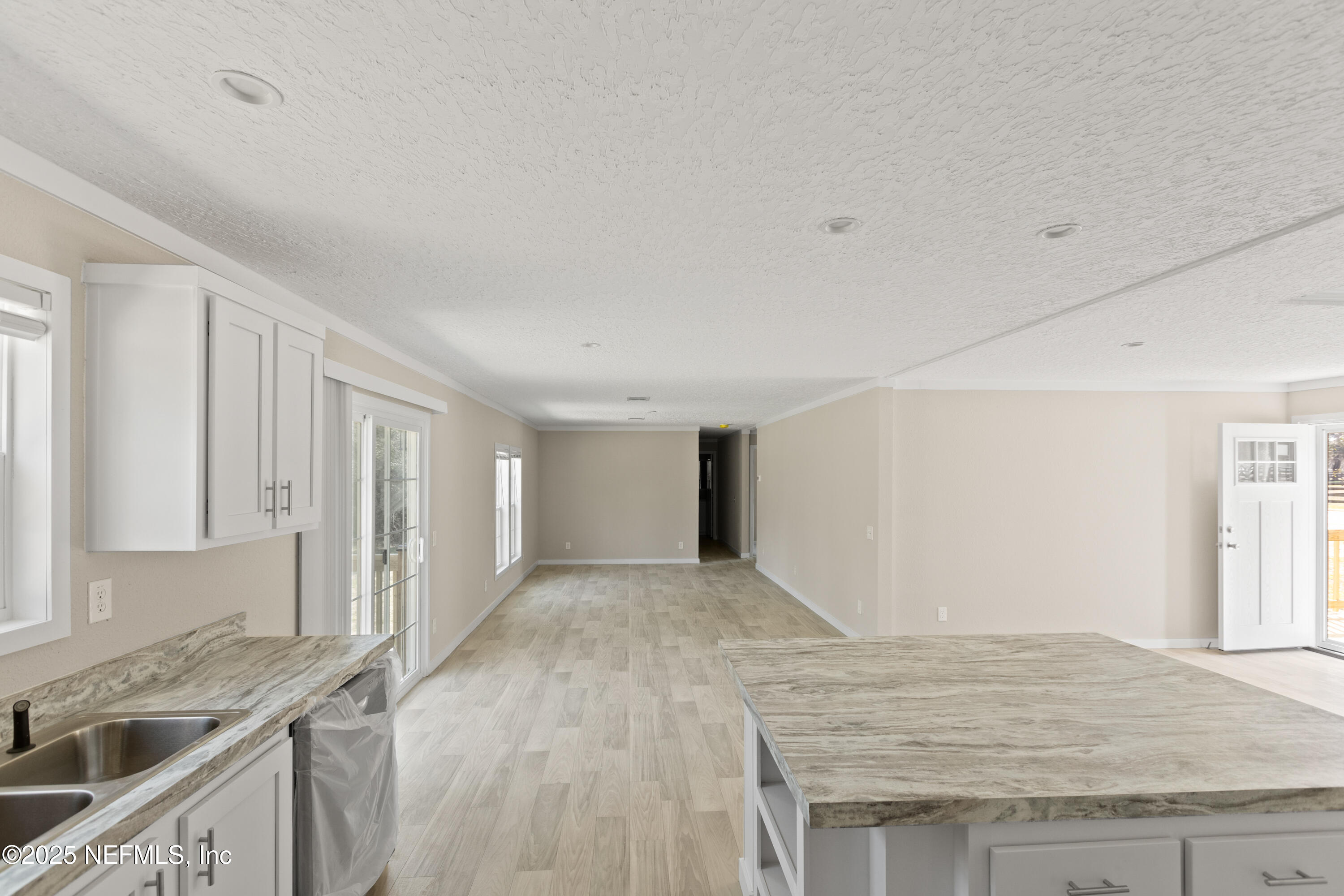 6012 Indian Trail Keystone Heights, FL 32656 - Photo 28 of 61 a kitchen with granite countertop a sink a stove and cabinets