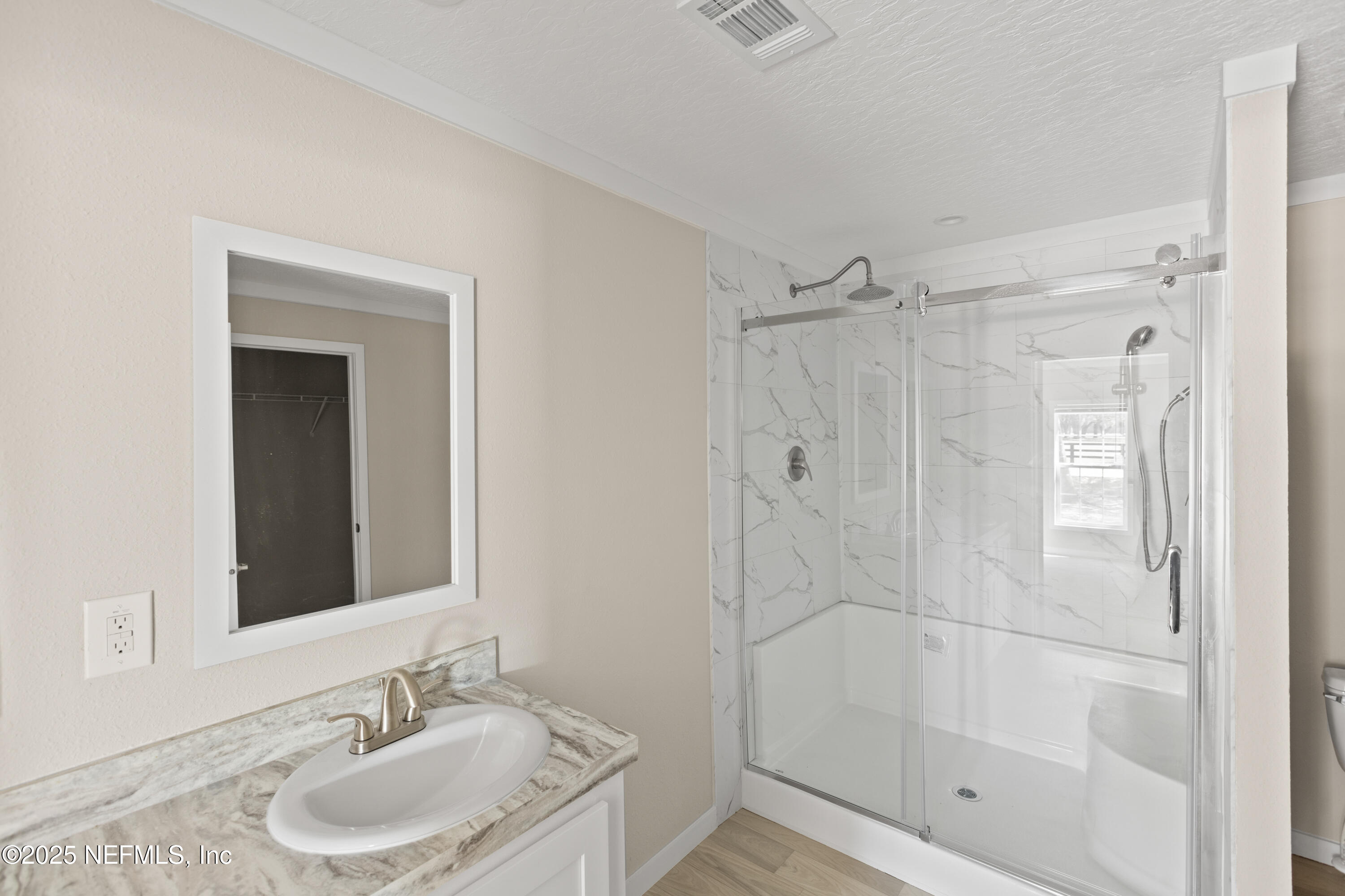 6012 Indian Trail Keystone Heights, FL 32656 - Photo 35 of 61 a bathroom with a shower sink vanity and mirror