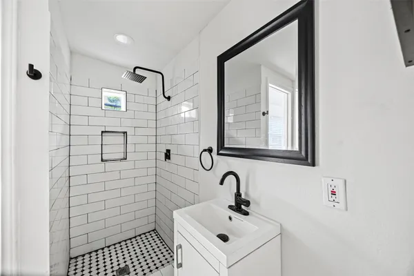 a bathroom with a sink and mirror