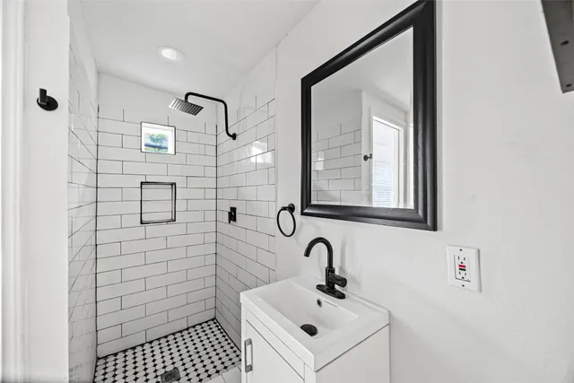 a bathroom with a sink and mirror