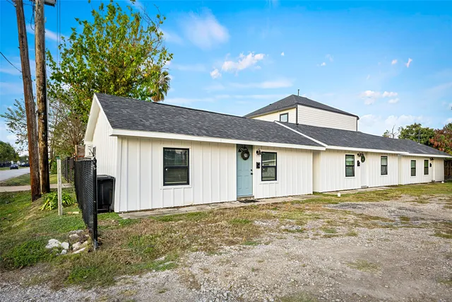 a front view of house with yard and trees