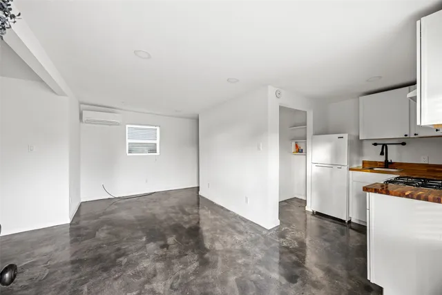 a kitchen with a refrigerator stove and a sink