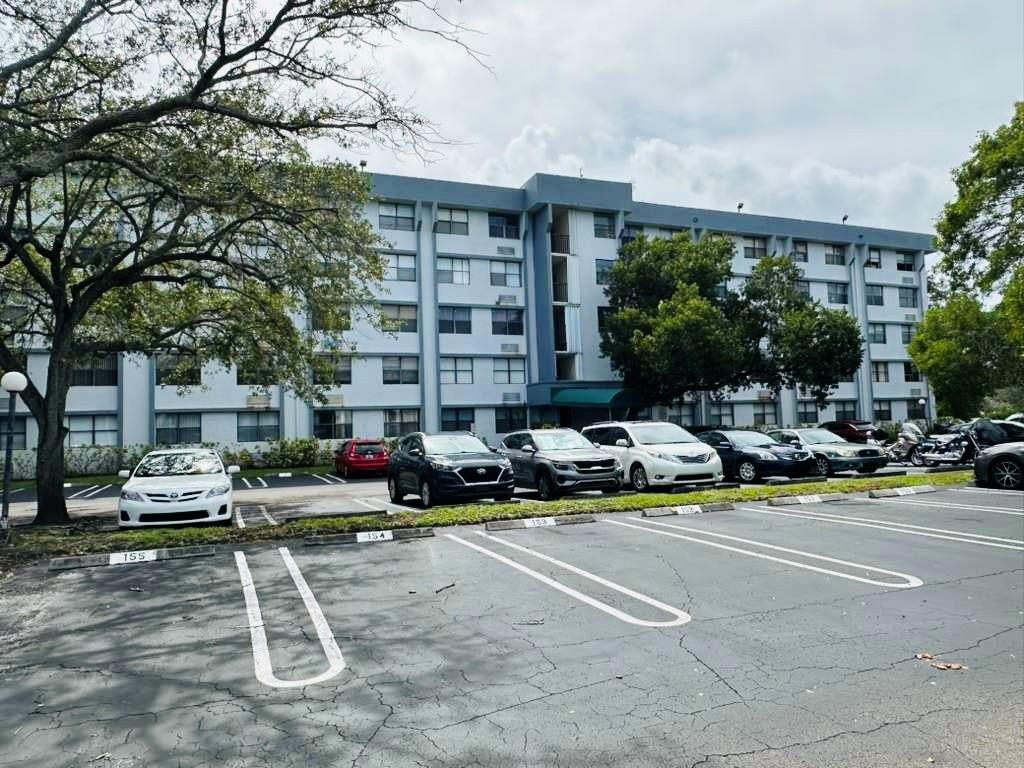 2401 Riverside Drive, Unit 212B Coral Springs, FL 33065 - Photo 2 of 9 a view of the patio with couches and a fire pit