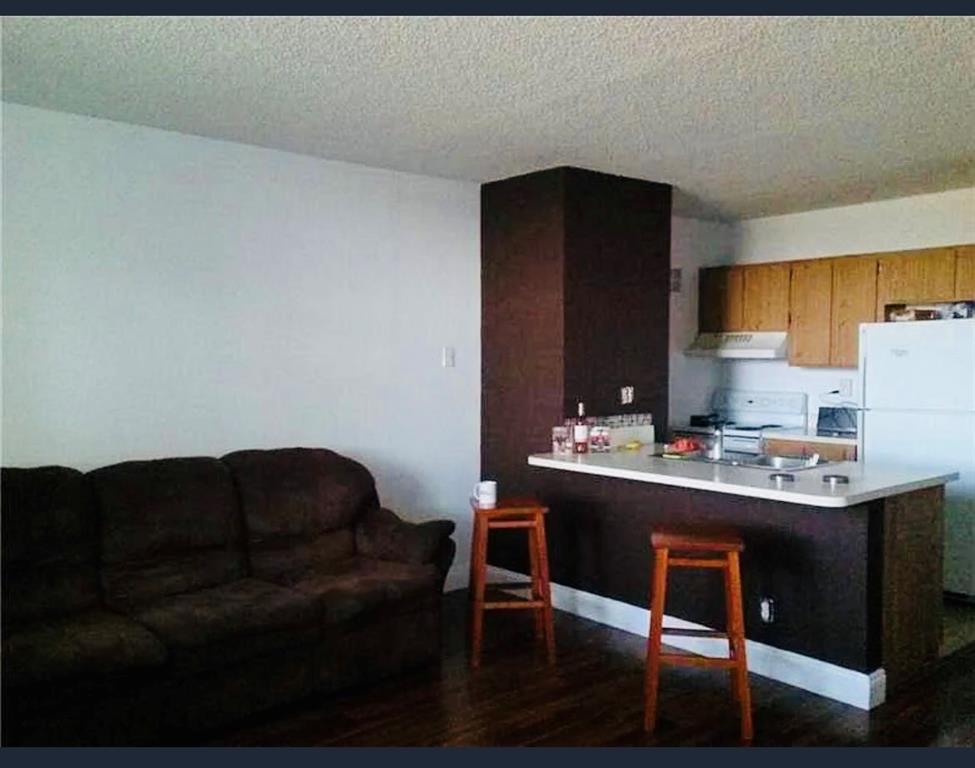 2401 Riverside Drive, Unit 212B Coral Springs, FL 33065 - Photo 4 of 9 a living room with furniture and a lamp