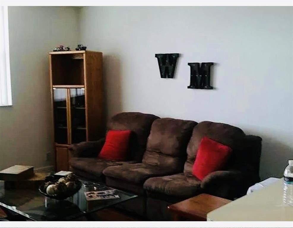 2401 Riverside Drive, Unit 212B Coral Springs, FL 33065 - Photo 7 of 9 a living room with furniture and a flat screen tv