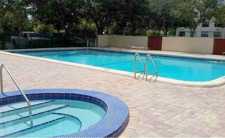 2401 Riverside Drive, Unit 212B Coral Springs, FL 33065 - Photo 9 of 9 a view of a swimming pool with a patio
