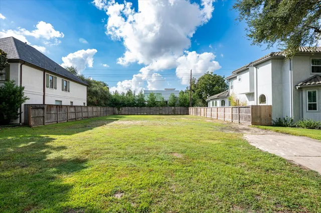 a view of swimming pool with a garden and trees