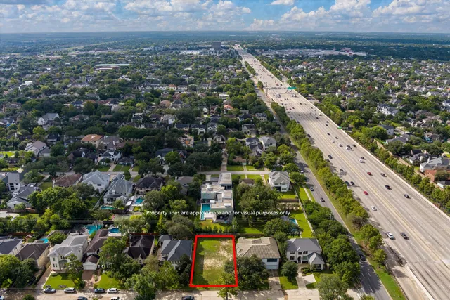 an aerial view of residential houses with yard and outdoor seating