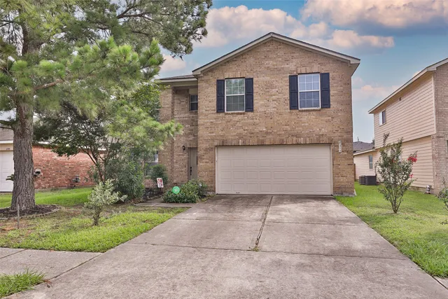 a front view of house with yard and trees