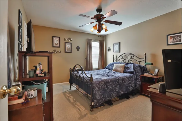 a bedroom with a bed and a chandelier