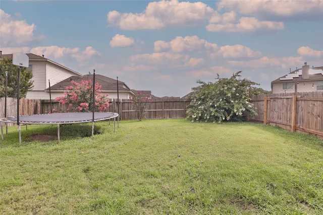 a backyard of a house with table and chairs