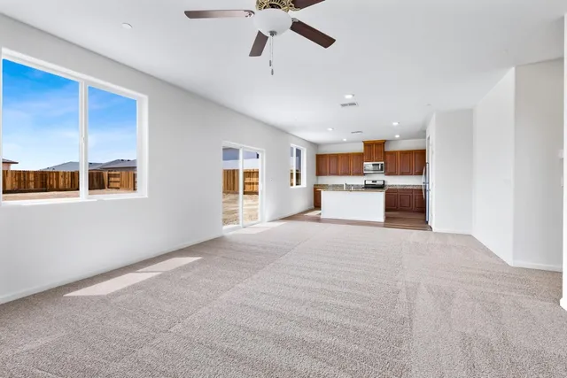 a view of a kitchen with furniture and a ceiling fan