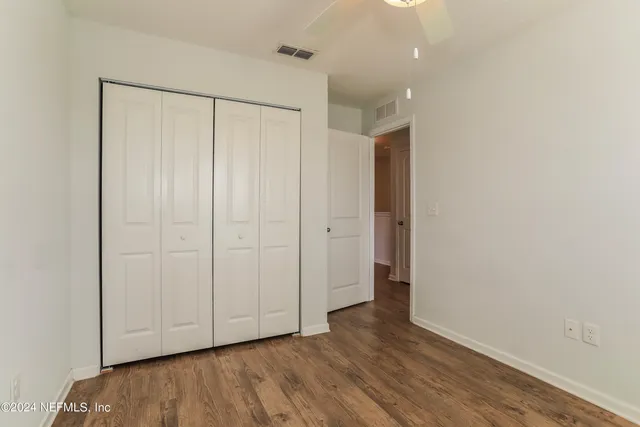 a view of an empty room with closet area