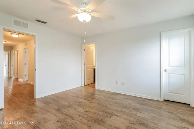 a view of an empty room and wooden floor