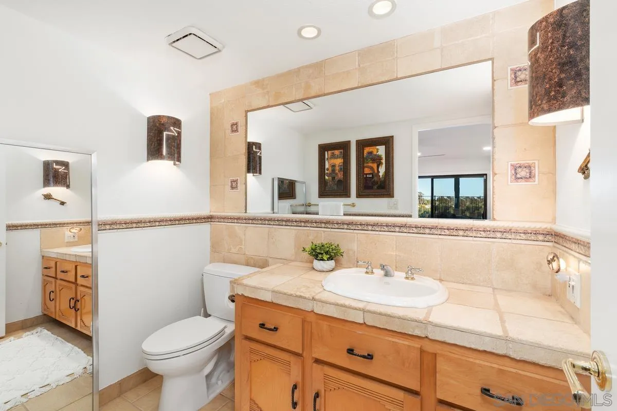 445 Via Savoy Encinitas, CA 92024 - Photo 15 of 39 a bathroom with a sink a toilet and vanity
