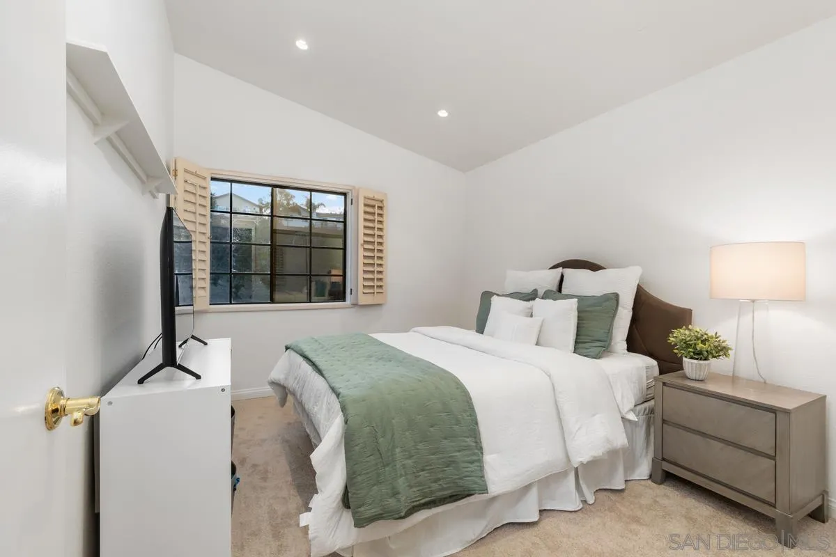 445 Via Savoy Encinitas, CA 92024 - Photo 20 of 39 a bedroom with a bed and a window