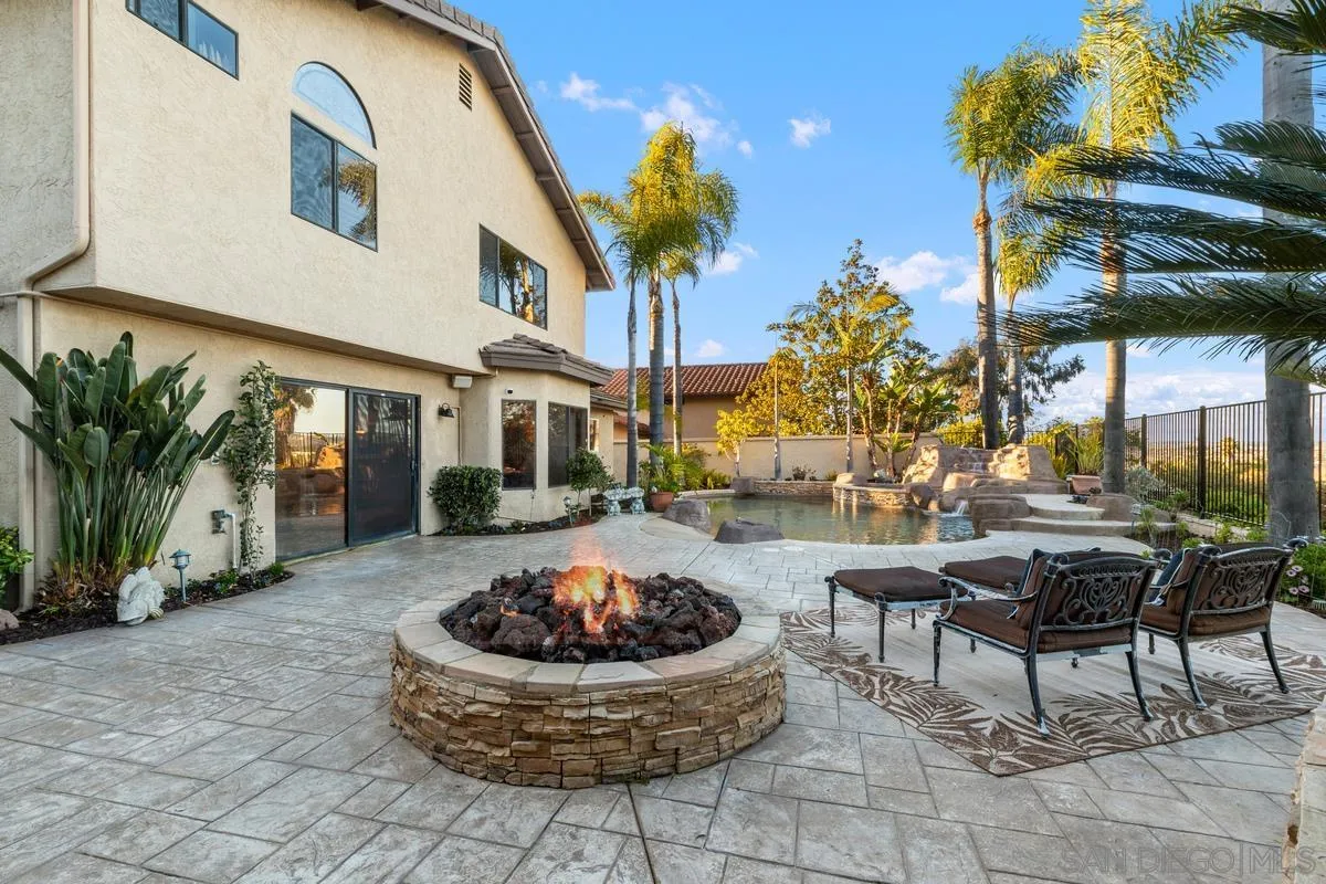 445 Via Savoy Encinitas, CA 92024 - Photo 27 of 39 a view of a backyard with table and chairs potted plants and palm tree