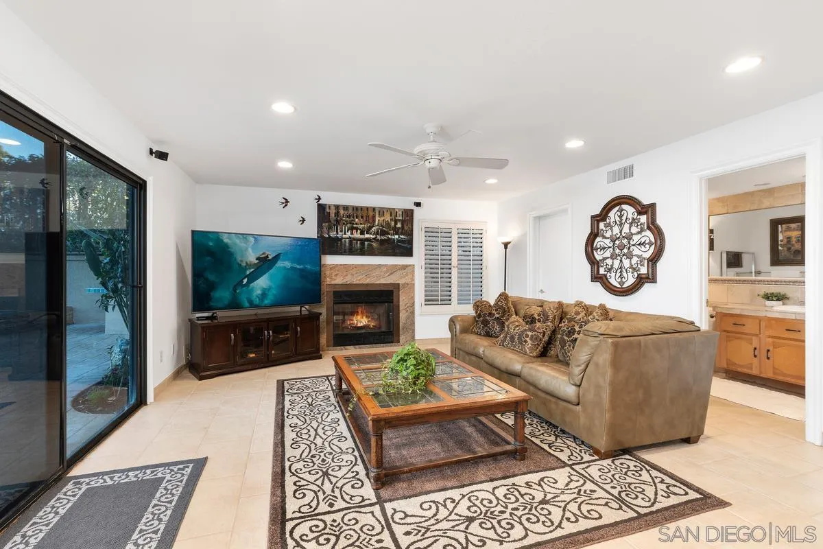 445 Via Savoy Encinitas, CA 92024 - Photo 9 of 39 a living room with furniture a rug and a fireplace