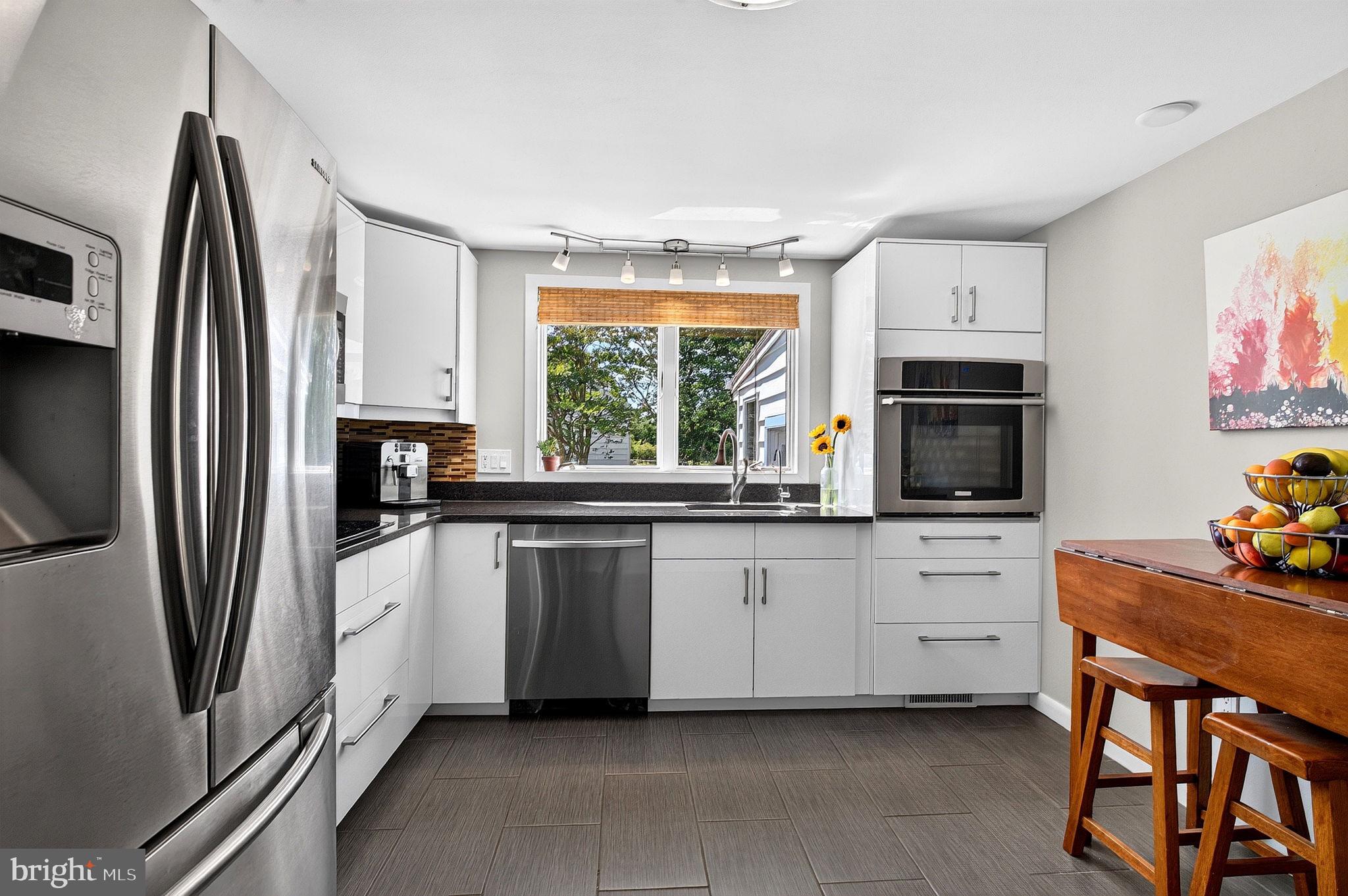 321 Buttonwood Street Hamilton, NJ 08619 - Photo 13 of 42 Sleek white cabinetry, black granite countertops
