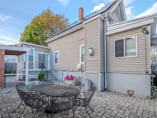 a view of a dinning table and chairs in the patio