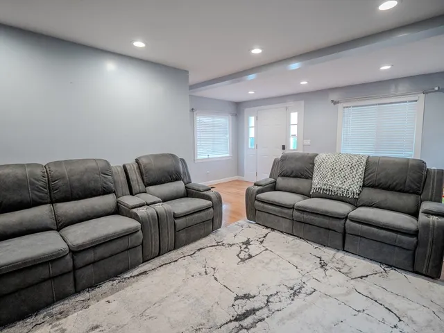 a living room with furniture a couch and a couch