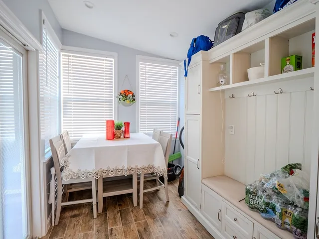 a dining room with furniture and wooden floor