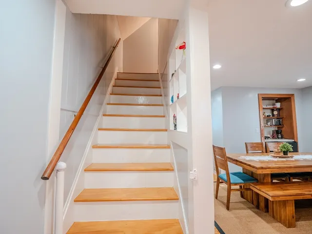 a view of entryway with wooden floor and dining room