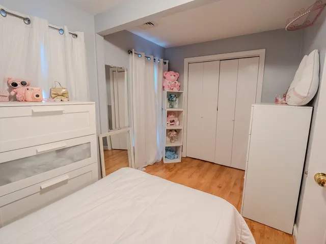 a bedroom with a bed and cabinets