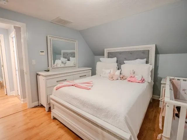 a bedroom with a bed and a mirror