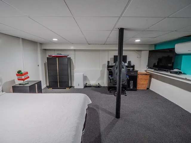 a bedroom with a bed a desk and chair