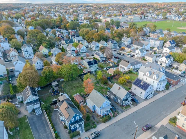 an aerial view of residential houses with outdoor space