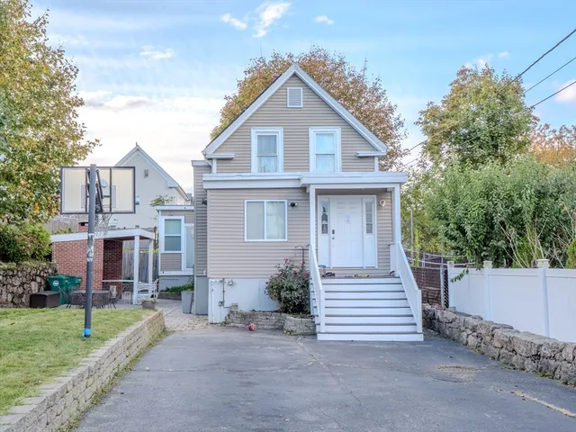a front view of a house with a garden